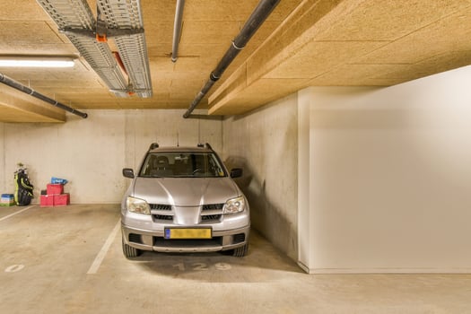 A gray car parked in a parking garage photo