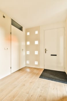A white door and wooden floor in a room photo