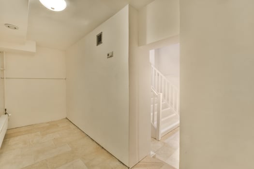A hallway with a white door and a white bathtub photo