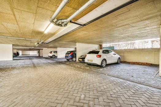 An empty parking garage with cars parked inside photo