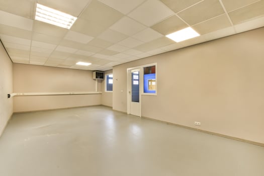 An empty room with a white ceiling and a door photo