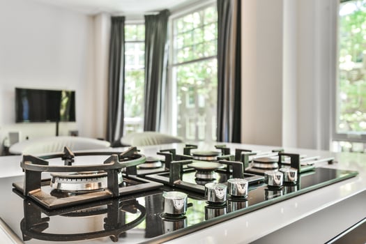 A kitchen with a stove top and a window photo