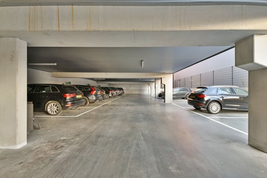 A parking garage with cars parked inside photo