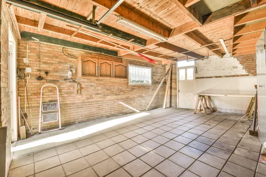 An empty room with a brick wall and ceiling photo