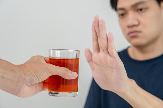man refuses say no and avoid to drink an alcohol whiskey , stopping hand sign male, alcoholism treatment, alcohol addiction, quit booze, Stop Drinking Alcohol. Refuse Glass liquor, unhealthy, reject photo