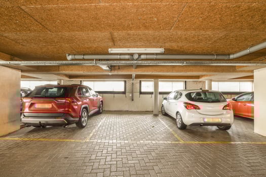 Three cars parked in a parking garage photo
