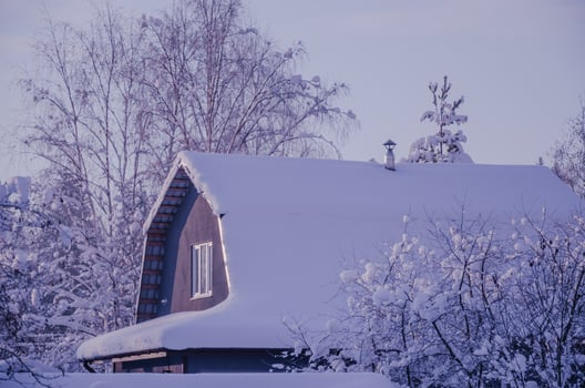 The roof of the house in winter is covered with snow photo