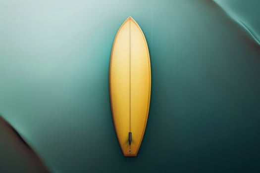 Aerial view of a yellow surfboard resting on tranquil ocean waters at sunrise photo