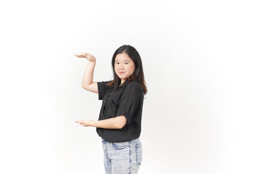 Young Asian woman Measuring and Showing Big Product wearing Black t-shirt and jeans isolated on white background photo