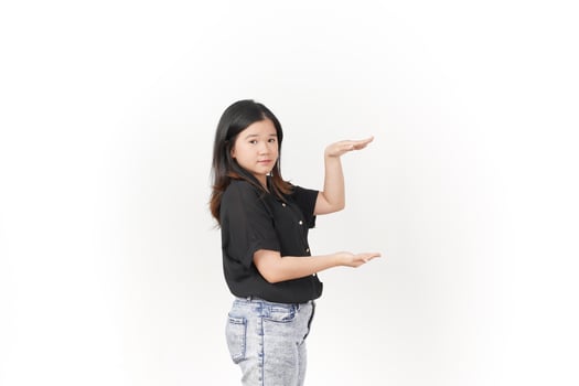 Young Asian woman Measuring and Showing Big Product wearing Black t-shirt and jeans isolated on white background photo
