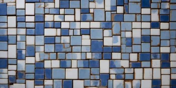 Wall with old blue and white square shaped tiles. photo