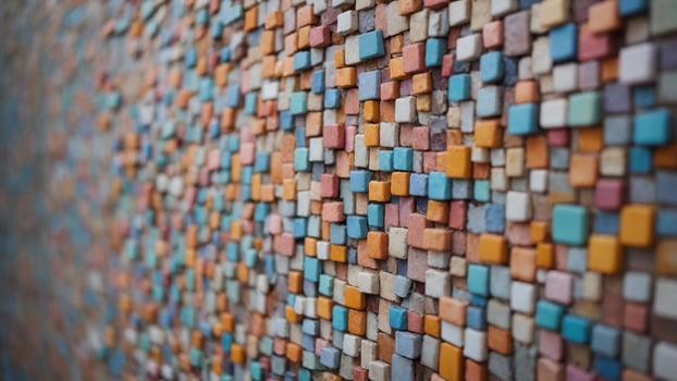 Wall with small square shaped pastel colored tiles. photo