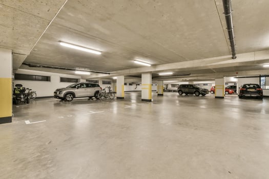 An empty parking garage with several cars parked in it photo