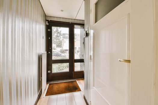 A hallway with a door and a wooden floor photo
