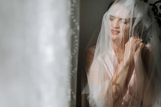 A woman is wearing a veil and is looking at the camera photo