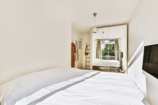 A bedroom with a bed and a television photo