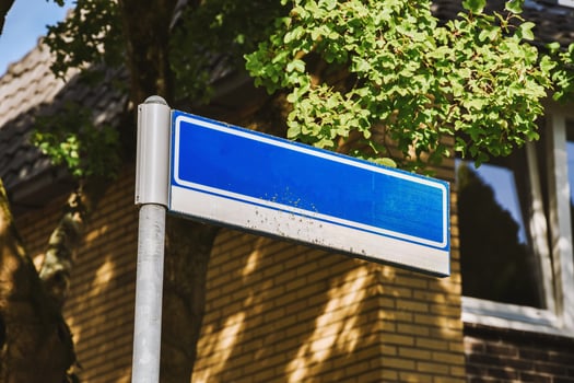 A blue street sign on a pole photo