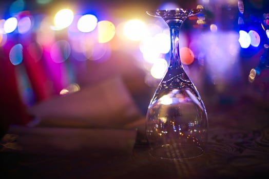 Wineglass outdoors on table by night photo