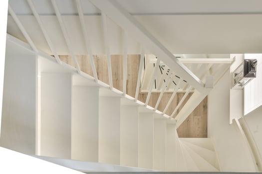 A white staircase with wooden handrail photo