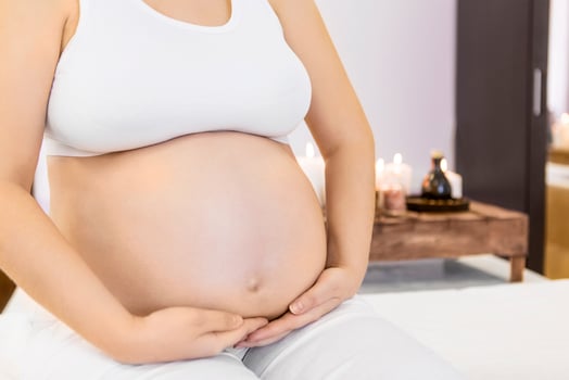 Young pregnant woman doing yoga at home photo