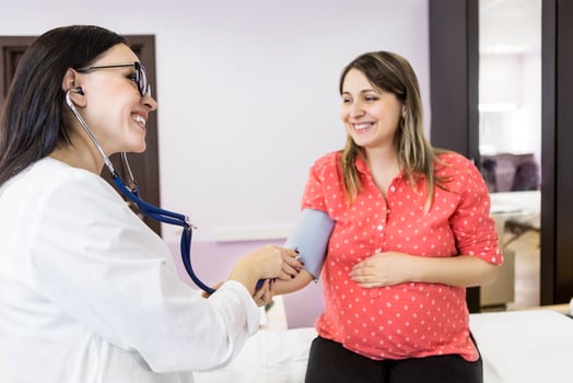 Young pregnant woman at doctors office photo