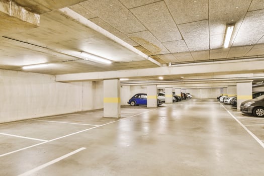 An empty parking garage with several cars parked in it photo