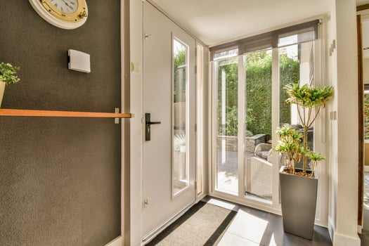 A hallway with a door and a clock on the wall photo