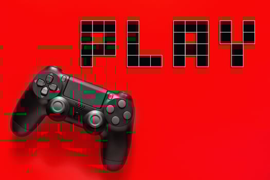 Black modern gamepad and word play on a colored background . Gaming concept photo