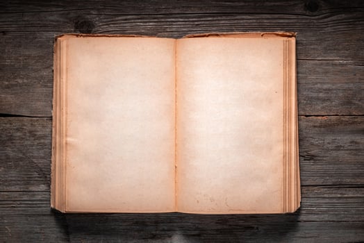 Vintage book, open, on old wooden table, with clipping path. Open Book blank on old wooden background. book with blank pages photo
