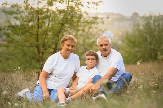 Grandfather grandmother and grandson having fun outdoors in park photo