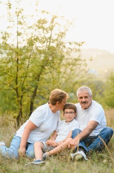 Grandfather grandmother and grandson having fun outdoors in park photo