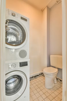 A bathroom with a washer and dryer photo