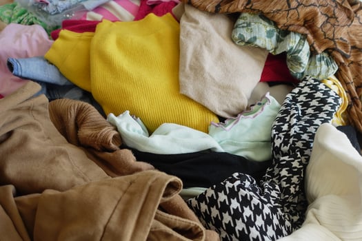 A Colorful and Textured Pile of Various Clothing Perfect for Fashion Design Inspiration photo