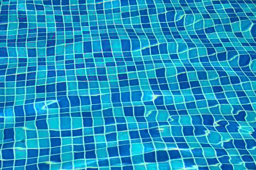 A blue pool shines on a summer day photo
