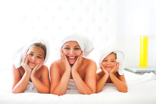 Mother and girls in bathrobes in room after shower photo