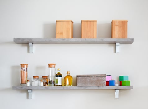 Arranged jars with various spices on kitchen shelves photo