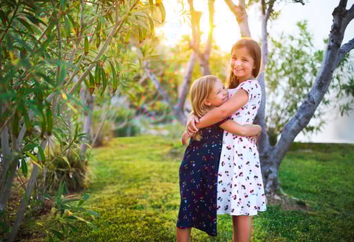 Happy funny sisters embrace together photo
