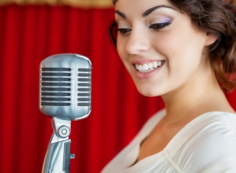 Beautiful woman singing with the microphone photo