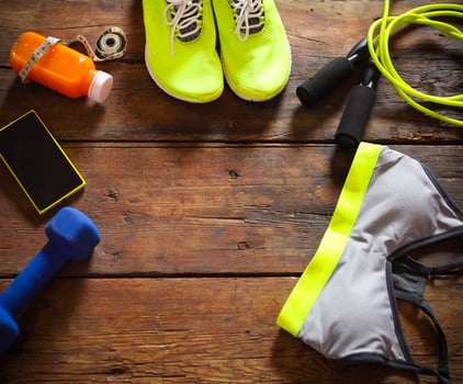 Female sport equipment on a wooden background photo