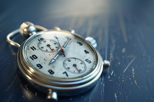 Vintage rusted chrome stopwatch is measuring time on blue background photo