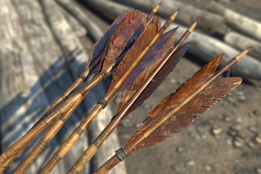 Five wooden arrows with carved feathers are pointing upwards photo