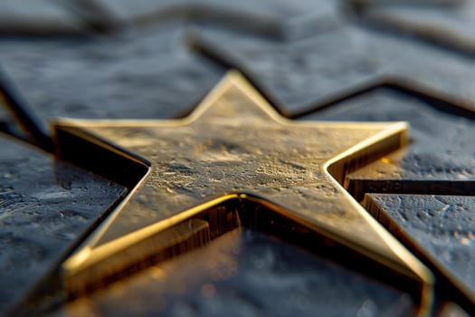 Golden star standing out from the crowd of silver stars photo