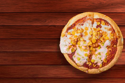 Pizza isolated on wooden table with copy space. photo
