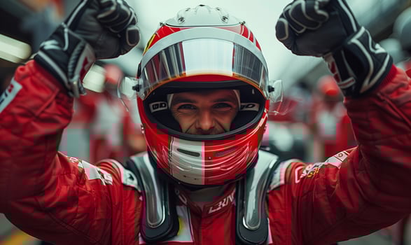 Formula one racing team driver cheering, celebrating victory on sports track photo