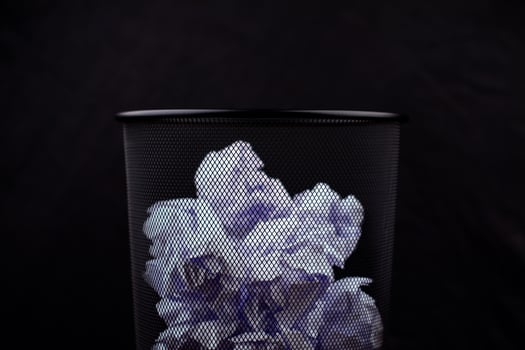 Waste paper basket, throwing waste into the trash, crumpled white paper, pile of waste paper photo