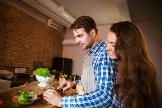 Young smiling couple cooking together photo