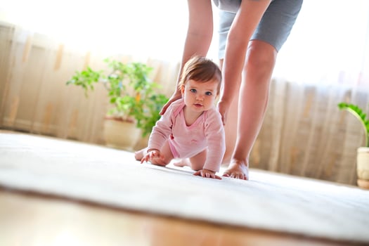 Baby girl playing with mother photo