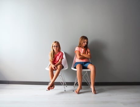 Furious teen girl in a discussion with her little photo