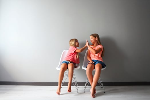 Happy girl in a discussion with her little. Problems decision between sisters concept photo