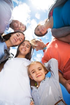 Group of happy smiling friends against blue sky photo